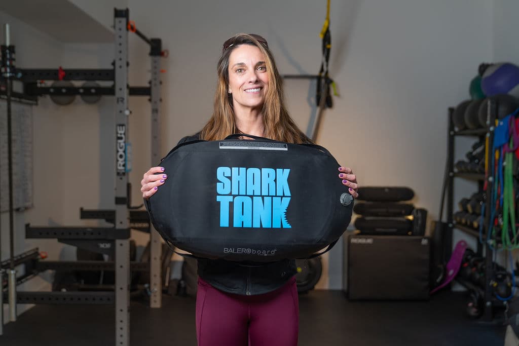 Karen Harbour smiling in her training studio, holding a BALEROboard